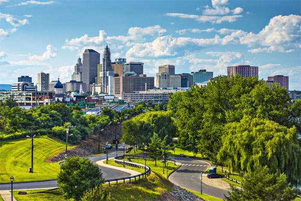 Image of the Hartford CT city skyline with trees in the foreground